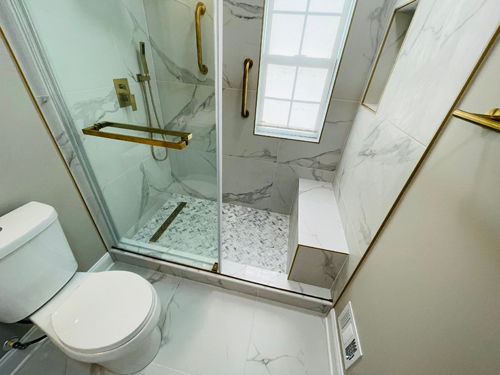 Home remodeling of a full small bathroom renovation which has been completed. Nice tile work and gold finishes.