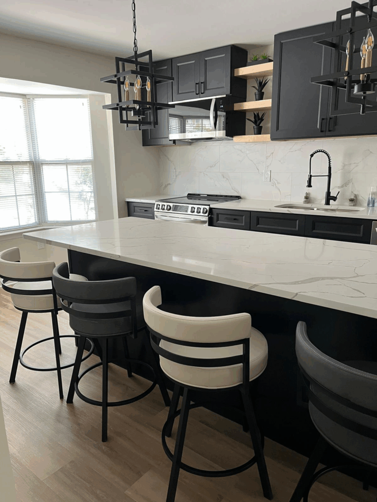 full kitchen remodel in Bowie, MD with black cabinets and calcatta laza quartz